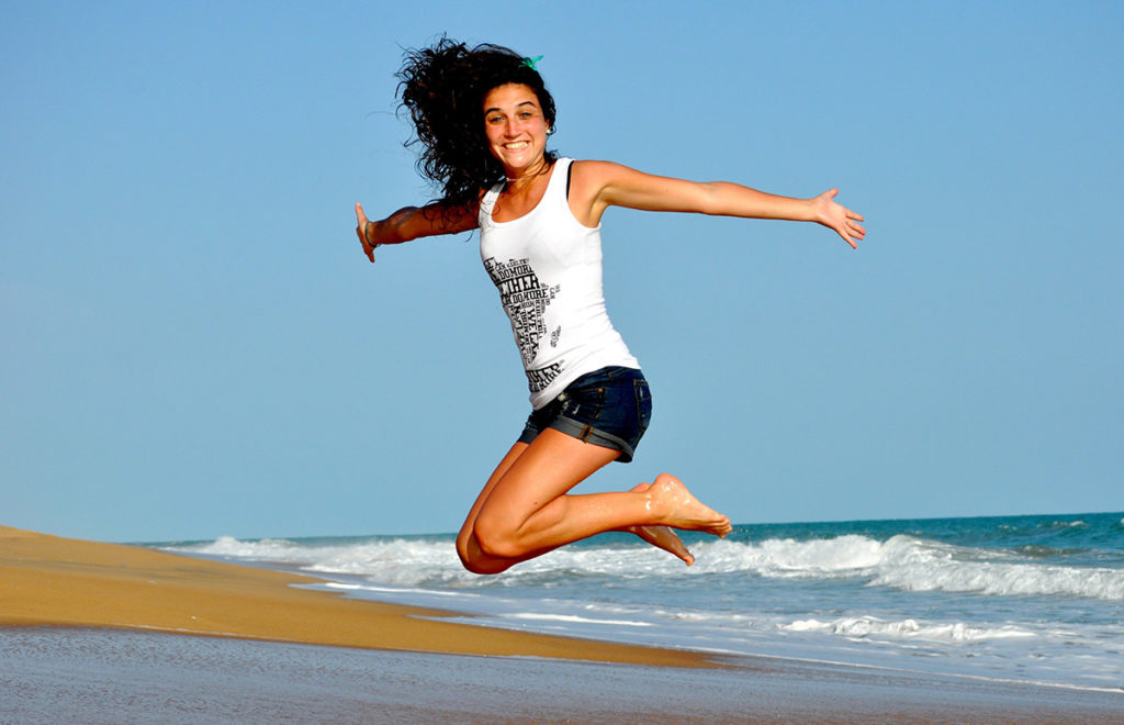 Jumping, Happy, Energetic Woman on the Beach